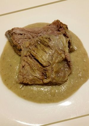 A picture of Slow roasted beef with bread and mushroom sauce.