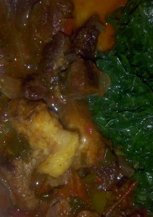 A picture of Beef stew with sauted kales.