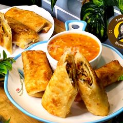 A picture of Veg And Chicken Spring Rolls With Homemade Sheets Or Wraps Along With Spring Roll Sauce.