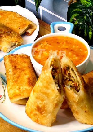 A picture of Veg And Chicken Spring Rolls With Homemade Sheets Or Wraps Along With Spring Roll Sauce.