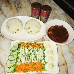 A picture of White rice wt chicken ball stew &salad wt devilled eggs.