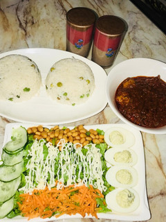 A picture of White rice wt chicken ball stew &salad wt devilled eggs.