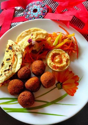 A picture of Pita bread with falafel hummus sandwich.