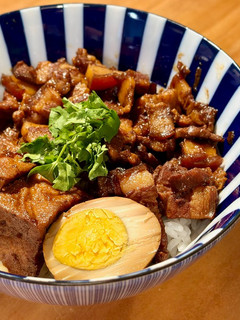 A picture of Braised Pork Rice with Braised Eggs and Fried Tofu.
