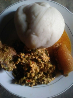 A picture of Pounded yam with vegetable egusi soup.