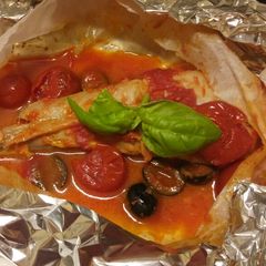 A picture of Rana pescatrice al cartoccio oven baked monkfish.