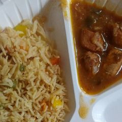 A picture of Vegetable rice and chicken stew.