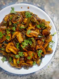 A picture of Mushroom stir fry with some homemade barbeque sauce.