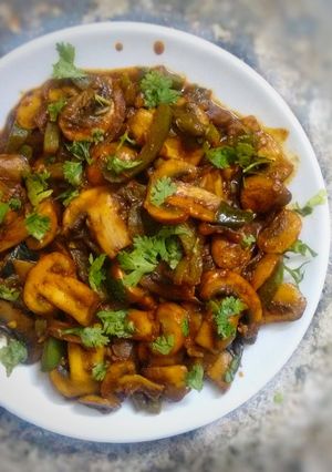 A picture of Mushroom stir fry with some homemade barbeque sauce.