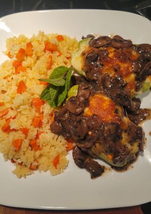 A picture of Stuffed Chayotes with White Rice and Mushroom Sauce.