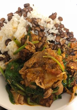 A picture of Rice and beans with chicken stew.