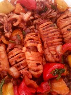 A picture of Grilled squid and stir fry vegetables.
