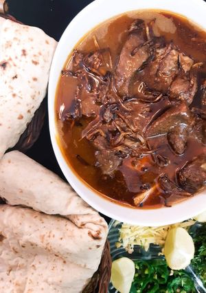 A picture of Beef Nihari with Naan.