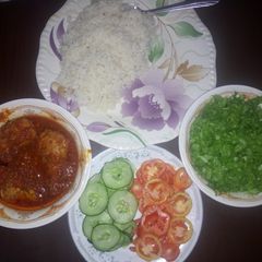 A picture of Rice and chicken stew with salad.