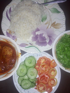 A picture of Rice and chicken stew with salad.