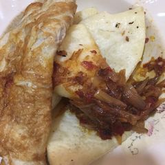 A picture of Fried yam,egg with onion sauce.