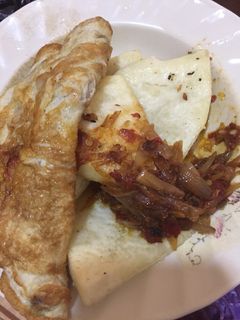 A picture of Fried yam,egg with onion sauce.