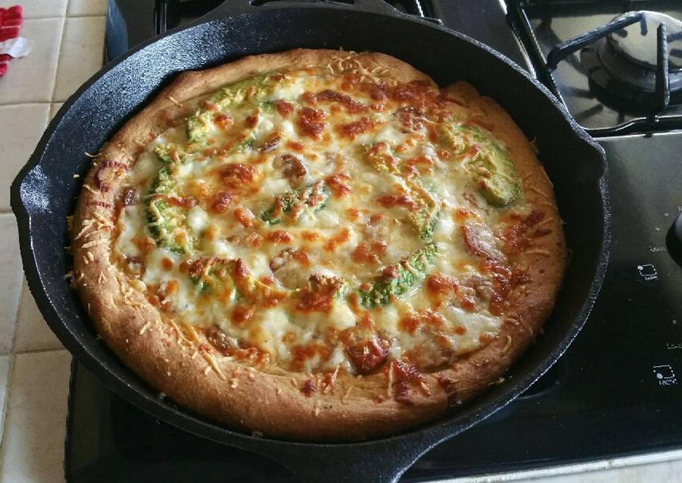 Deep-fried homemade pizza in a cast iron skillet
