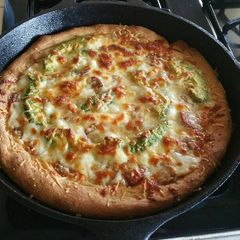 A picture of Homemade Deep Dish Pizza in a Cast Iron Skillet.