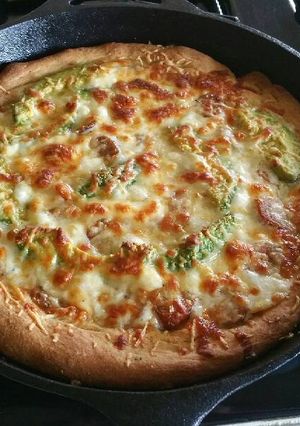 A picture of Homemade Deep Dish Pizza in a Cast Iron Skillet.
