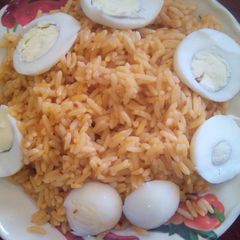 A picture of Jellof rice and boiled eggs.