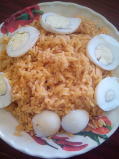 A picture of Jellof rice and boiled eggs.