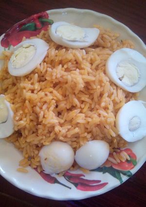 A picture of Jellof rice and boiled eggs.
