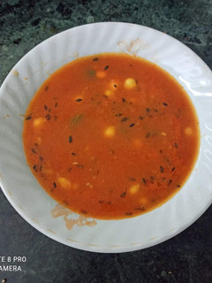 A picture of Tomato Carrot Corn soup with some roasted jeera flavour.