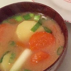 A picture of Vegan Miso soup with carrot, potato and spring onion.