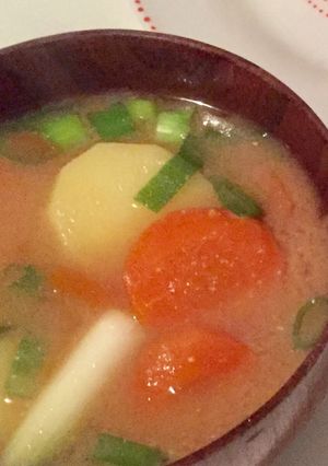 A picture of Vegan Miso soup with carrot, potato and spring onion.