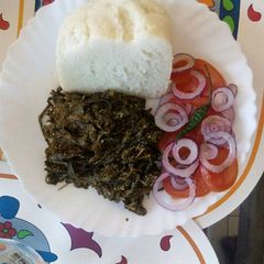 A picture of Coconut cooked managu/osuga/mnavu and ugali.
