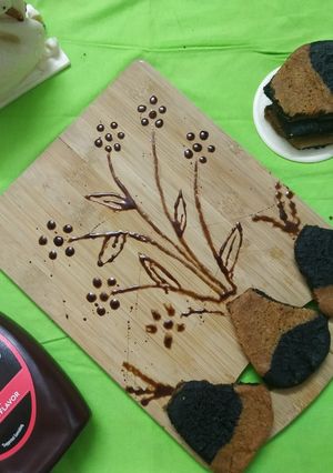 A picture of Choco-Vanilla Cookies(Vase Shaped-Flowers Paint Chocolate Syrup).