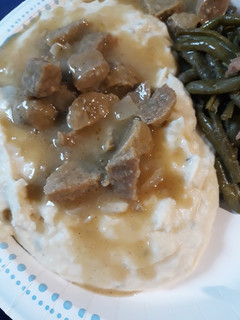 A picture of Mashed Potatoes and Meatball Sauce.
