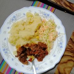 A picture of Mashed potato, beef fry and coleslaw.