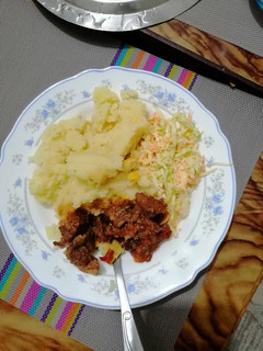 A picture of Mashed potato, beef fry and coleslaw.