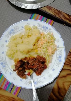 A picture of Mashed potato, beef fry and coleslaw.