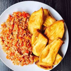A picture of Scrambled eggs and sweet Potato fries.