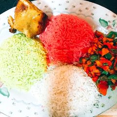 A picture of Colorful Christmas Rice with Veggies and grilled Chicken.