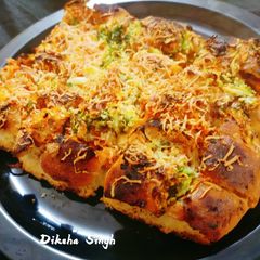 A picture of Stuffed Schezwan Cheesy Pav .