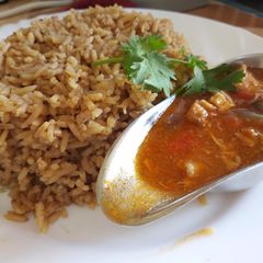 A picture of Pilau with chunky chicken soup.