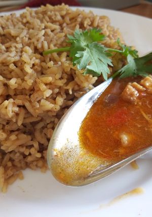 A picture of Pilau with chunky chicken soup.