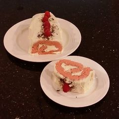 A picture of Fresh Rasberry Cake Roll with Whipped White Chocolate Ganache Filling and Frosting.