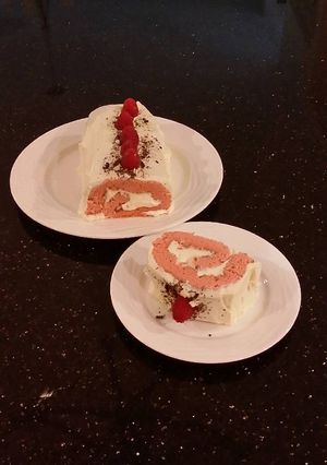 A picture of Fresh Rasberry Cake Roll with Whipped White Chocolate Ganache Filling and Frosting.