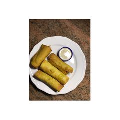 A picture of Spring rolls and a garlic dip.