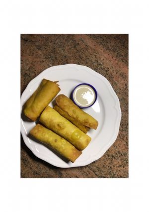 A picture of Spring rolls and a garlic dip.