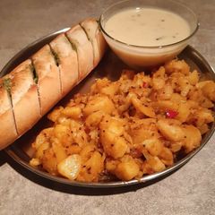A picture of Potato sabji,garlic bread and kadhi.