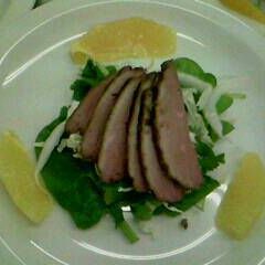 A picture of Duck and segmented orange salad.