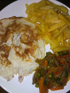 A picture of Chips,fried egg and veggies sauce.