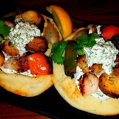 A picture of Mike's Chicken Kabobs With Tatziki Sauce & Naan Bread.