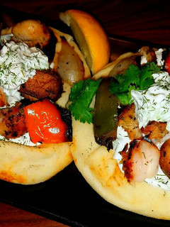 A picture of Mike's Chicken Kabobs With Tatziki Sauce & Naan Bread.